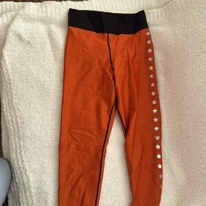 Ultracor women’s leggings - orange with reflective stars on side Size large